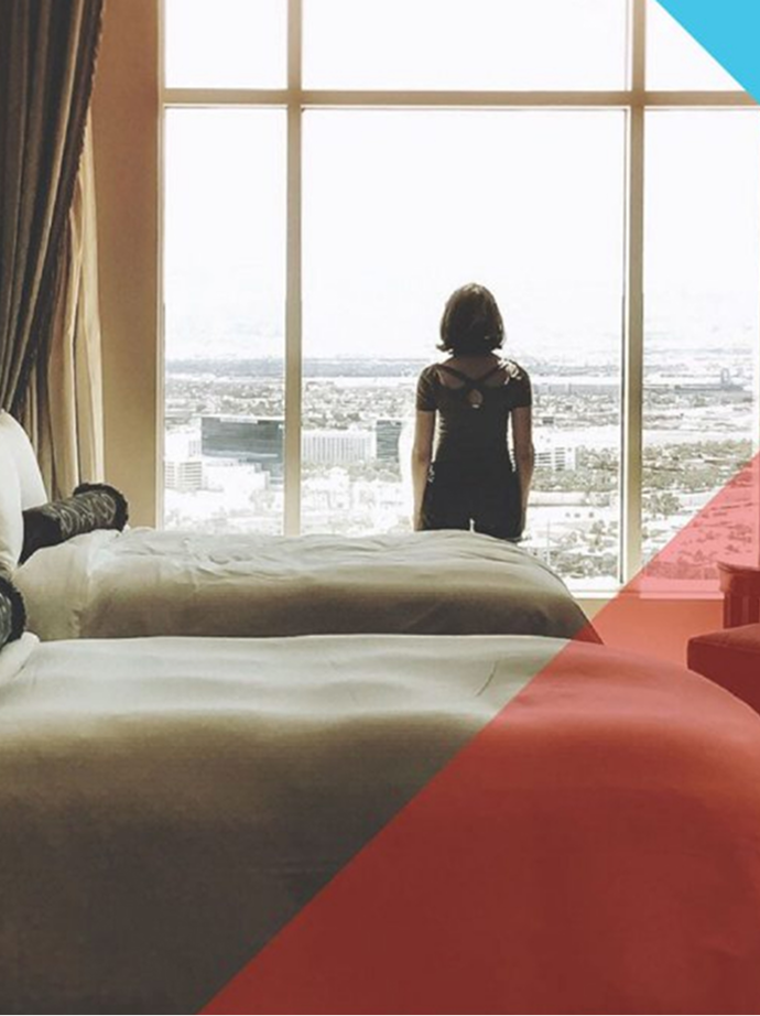 Flight Center Business Travel image of a hotel guest looking out of a window onto a runway