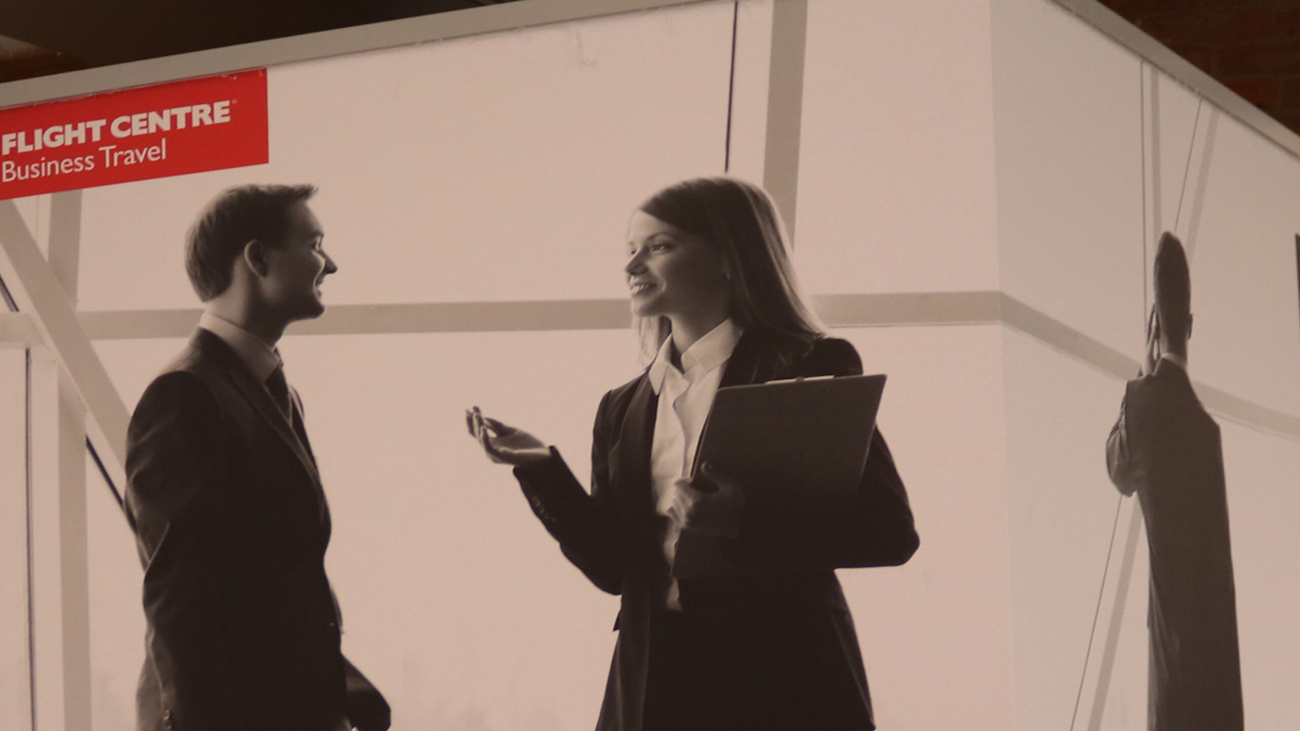 Flight Center Business Travel photography of two passengers talking to each other