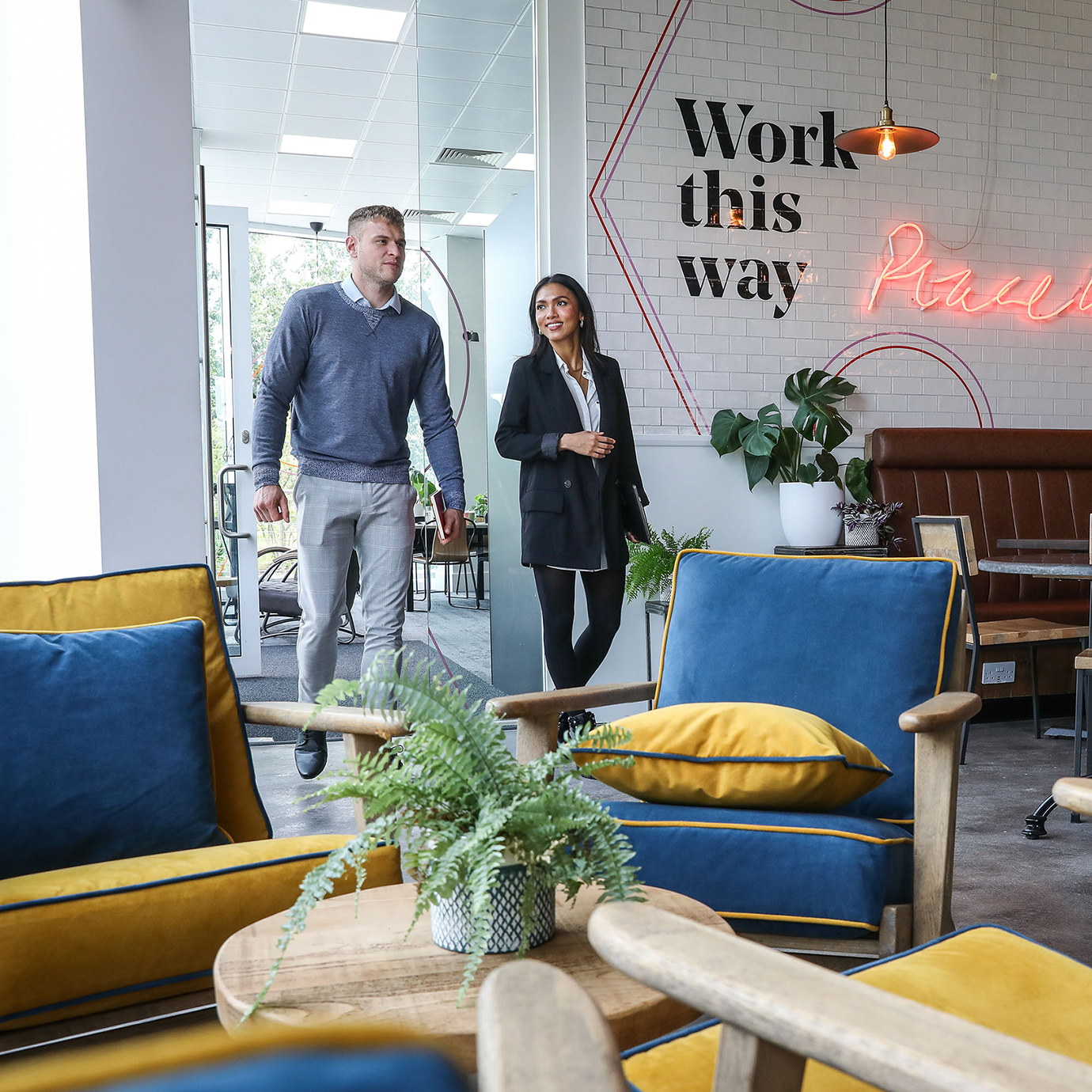 2 happy employees walking into a Frasers Property UK Winnersh Triangle cafe