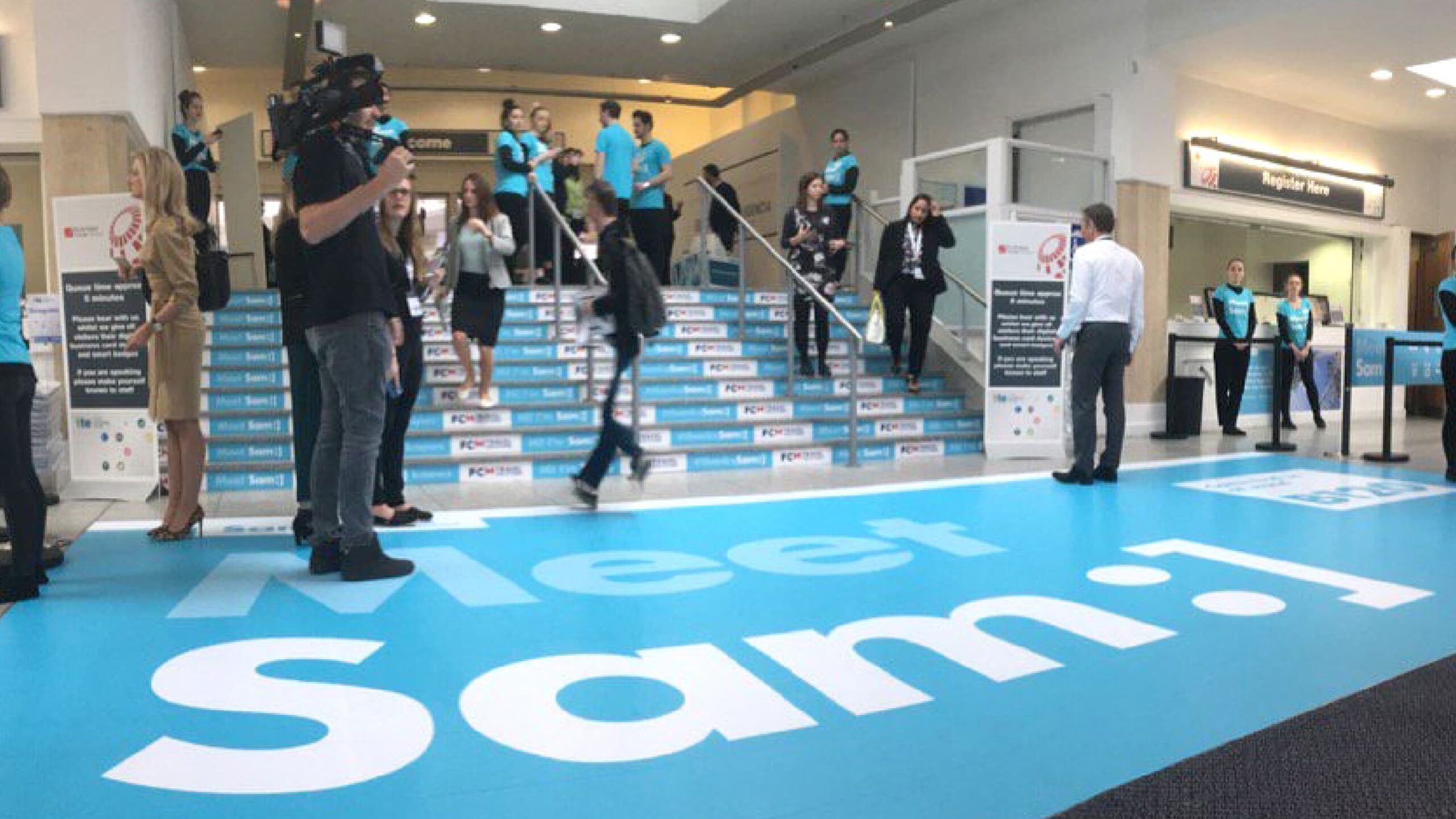 Meet sam floor graphic at the entrance of a event