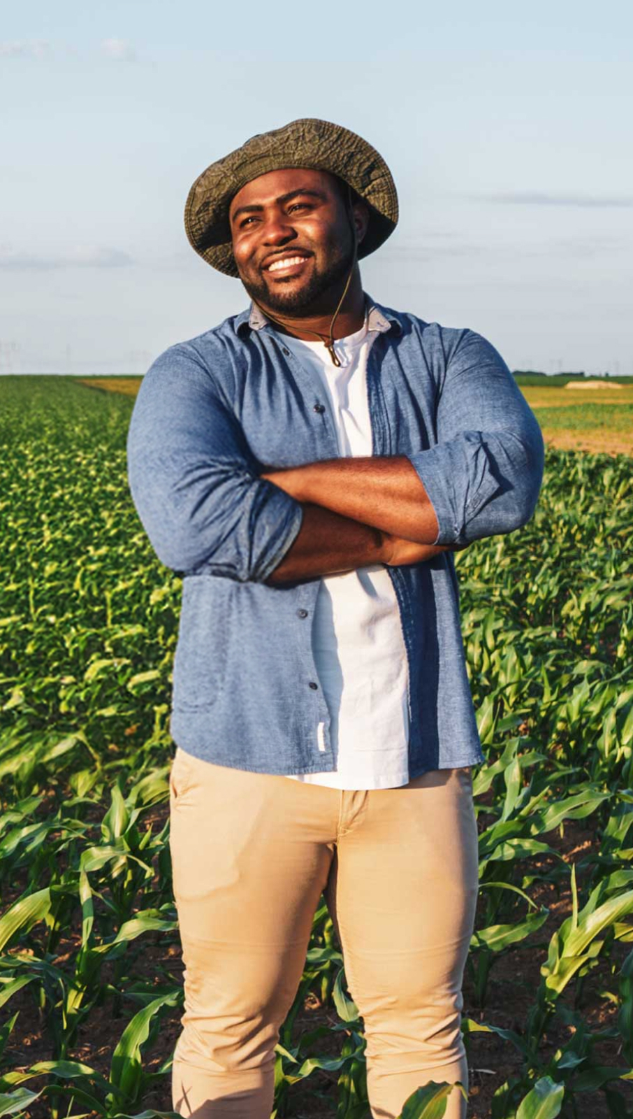 Happy African grower in a field of crops